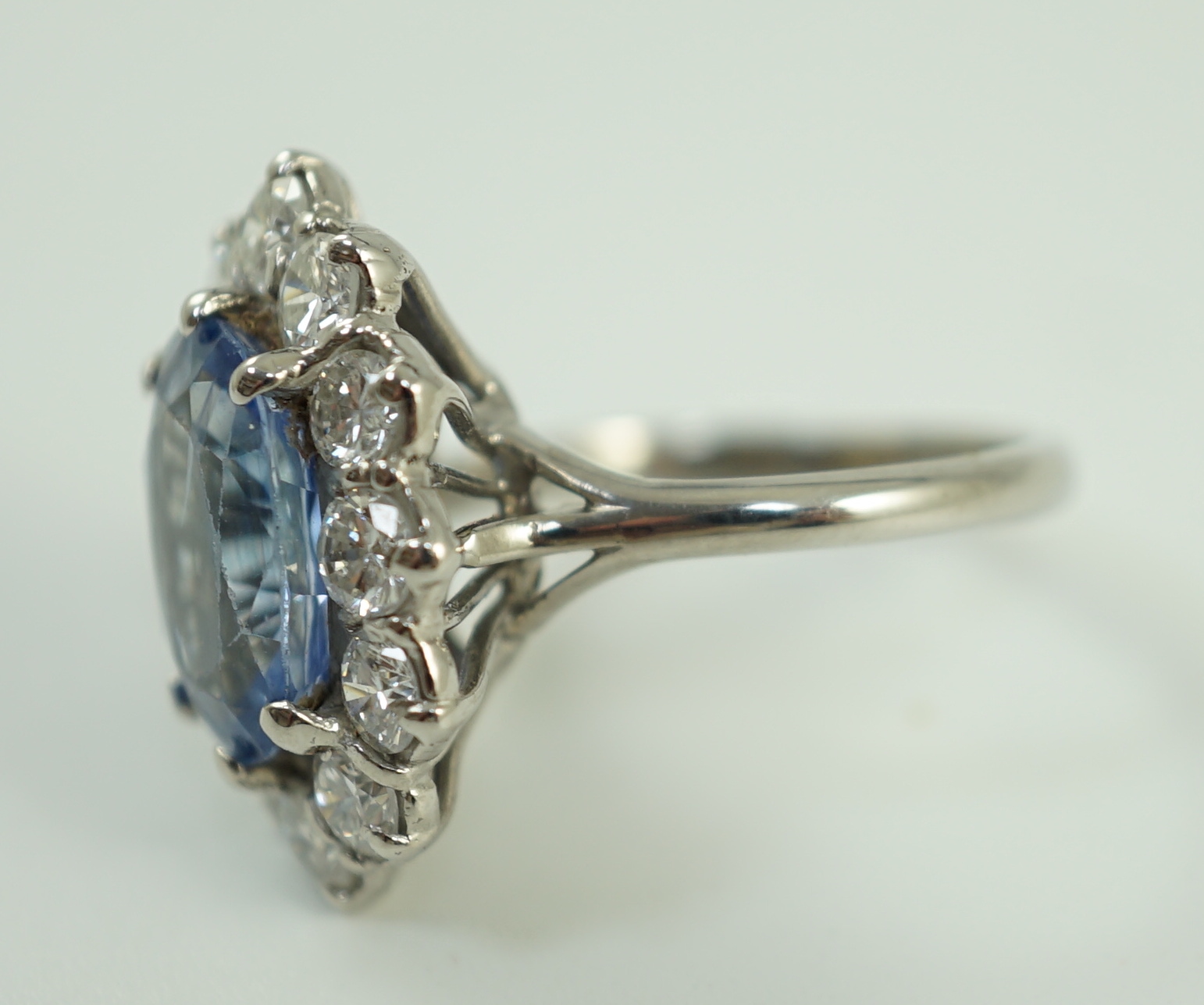 An 18ct white gold and platinum, aquamarine and diamond set oval cluster dress ring